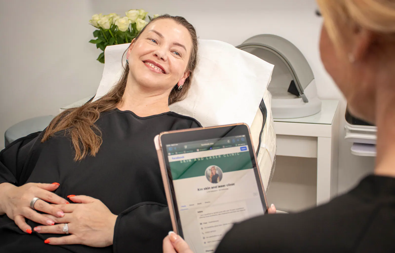 A consultation in the treatment room with a client seated comfortably.