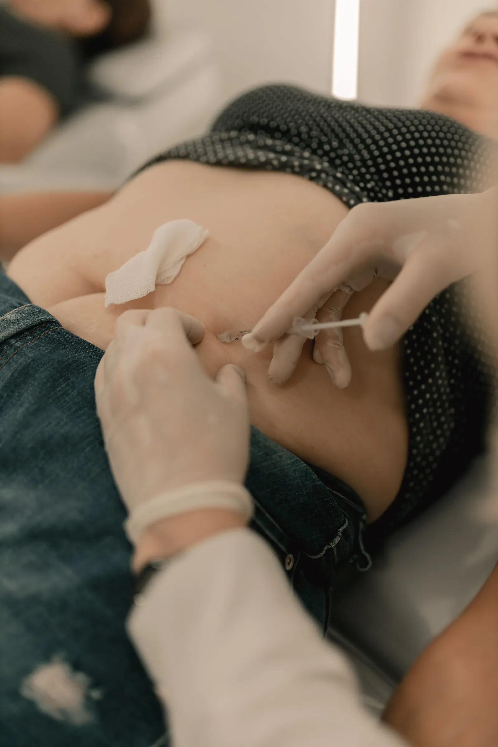 A localised abdomen injection treatment being carried out in a clinic setting.